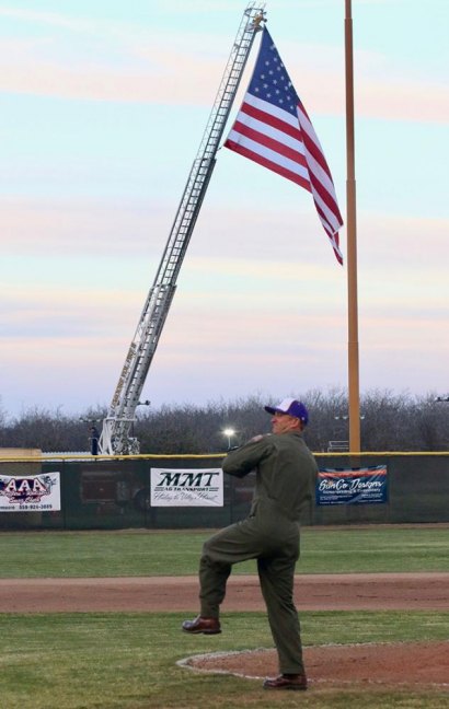 Navy Lt. Cmdr. Ben Charles throws out the first pitch during Friday night's Lemoore High School baseball game. He was there for the Tigers' annual Military Appreciation Night.
